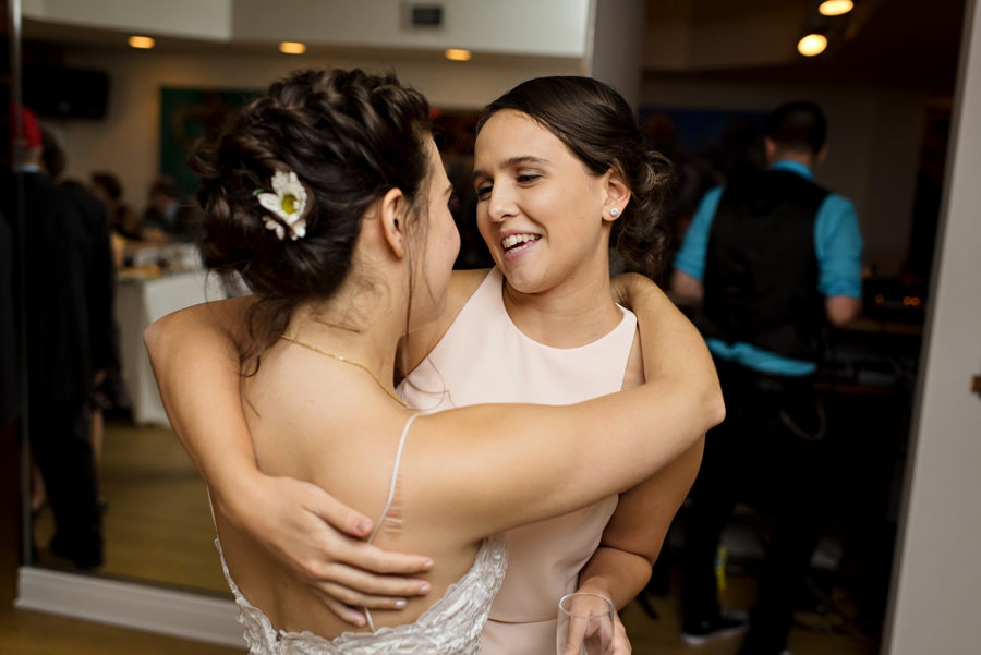 A bride hugging her maid of honor after her speech.